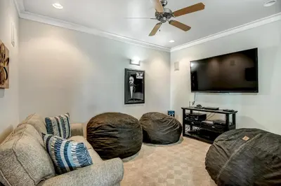 a living room with two bean chairs and a flat screen tv at Sea It All in Santa Rosa Beach