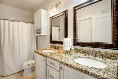 a bathroom with two sinks and a toilet at Sea It All in Santa Rosa Beach