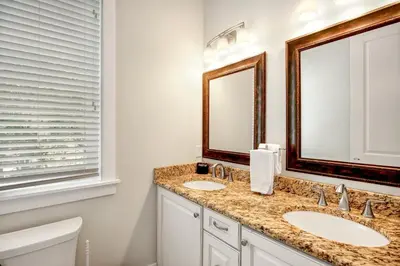 a bathroom with two sinks and a mirror at Sea It All in Santa Rosa Beach