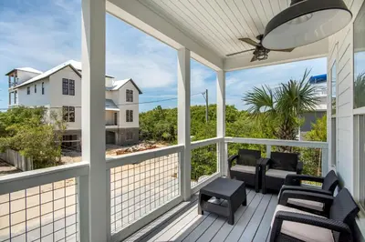 a screened porch with a view of the ocean at Sea It All in Santa Rosa Beach