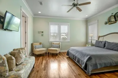 a bedroom with a bed and a couch at Sea It All in Santa Rosa Beach
