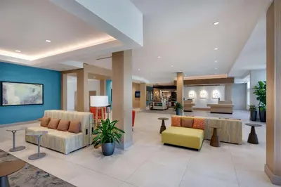 a lobby with couches and chairs in a hospital at Hilton Garden Inn Panama City Airport, Fl in Panama City