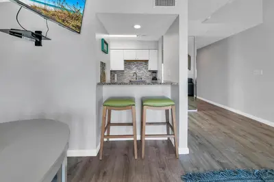 a kitchen with two bar stools and a counter at Endless Summer F9 in Panama City Beach