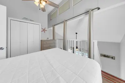 a white bedroom with a large white bed at Endless Summer F9 in Panama City Beach