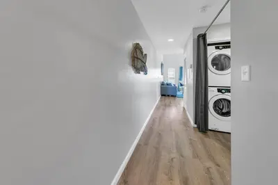a hallway with a washer and dryer in a house at Endless Summer F9 in Panama City Beach
