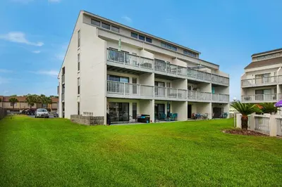 an apartment building with a lawn in front of it at Endless Summer F9 in Panama City Beach