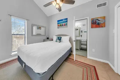 a bedroom with a bed and a ceiling fan at Endless Summer F9 in Panama City Beach