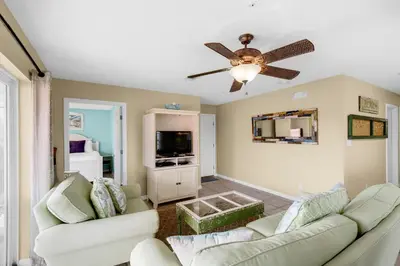 a living room with two couches and a ceiling fan at Rollin Tide Villas- Rollin Tide B9 in Santa Rosa Beach
