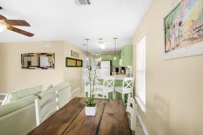a living room and kitchen with a table and a couch at Rollin Tide Villas- Rollin Tide B9 in Santa Rosa Beach