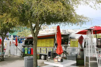 a food truck with a table and a red umbrella at Rollin Tide Villas- Rollin Tide B9 in Santa Rosa Beach
