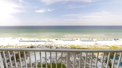 a view of the beach from the balcony of a resort at Dunes of Panama E-1006 in Panama City Beach