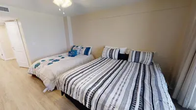 two beds sitting next to each other in a bedroom at Dunes of Panama E-1006 in Panama City Beach
