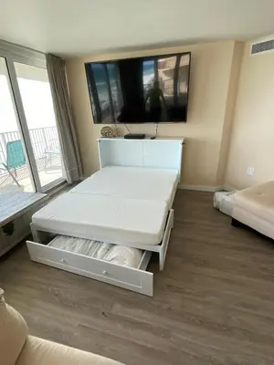a room with two beds and a large window at Dunes of Panama E-1006 in Panama City Beach