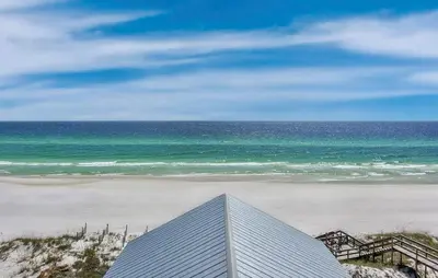 a view of a beach and the ocean with a building at Ocean Air Upper West Private Beach Unit on 30A in Santa Rosa Beach