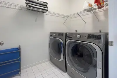 a laundry room with a washing machine and a drying rack at Ocean Air Upper East Private Beach unit on 30A in Santa Rosa Beach