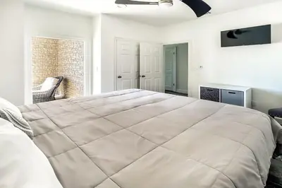 a large white bed in a room with a window at Ocean Air Lower West Private Beach Unit on 30A in Santa Rosa Beach