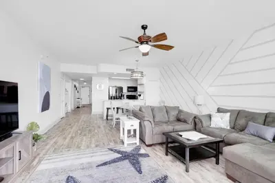 a living room with a couch and a table at Aqua Resort 1705 in Panama City Beach