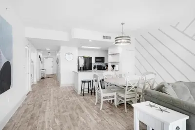 a living room with a couch and a table at Aqua Resort 1705 in Panama City Beach