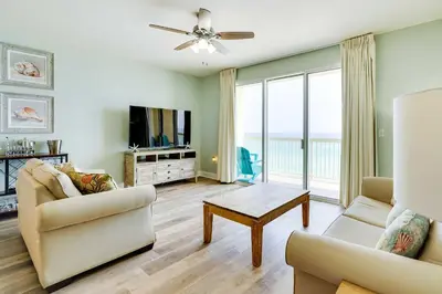 a living room with a couch and a table at Beachfront PCB Condo with Ocean View and Pool Access! in Panama City Beach