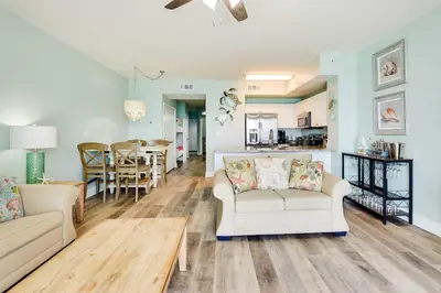 a living room with two couches and a dining room at Beachfront PCB Condo with Ocean View and Pool Access! in Panama City Beach