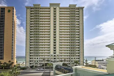 a tall building with the ocean in the background at Beachfront PCB Condo with Ocean View and Pool Access! in Panama City Beach