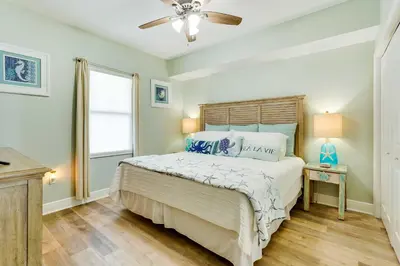 a bedroom with a bed and a ceiling fan at Beachfront PCB Condo with Ocean View and Pool Access! in Panama City Beach
