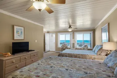 a bedroom with a bed and a flat screen tv at 111 The Shores in Sunnyside