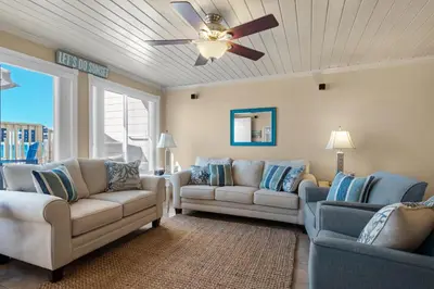 a living room with two couches and a ceiling fan at 111 The Shores in Sunnyside