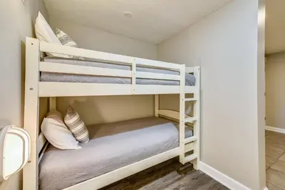 a bedroom with two bunk beds in a room at Grand Panama Beach Resort #908-1 by Book That Condo in Panama City Beach