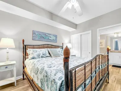 a bedroom with a bed and a ceiling fan at Grandview East 302 - Sandscape in Panama City Beach