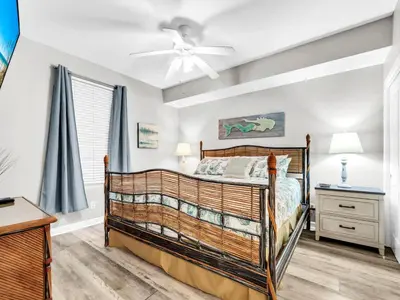 a bedroom with a bed and a ceiling fan at Grandview East 302 - Sandscape in Panama City Beach