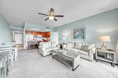 a living room with a couch and a ceiling fan at On the 3-d Floor, Laketown 324 - Large 2 BD , Great Views and Amenities in Panama City Beach