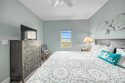 a bedroom with a bed with a television and a dresser at On the 3-d Floor, Laketown 324 - Large 2 BD , Great Views and Amenities in Panama City Beach