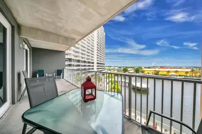 a balcony with a glass table and a view of the water at On the 3-d Floor, Laketown 324 - Large 2 BD , Great Views and Amenities in Panama City Beach