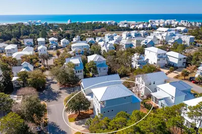 an aerial view of a neighborhood with houses and the ocean at Vitamin Sea in Inlet Beach