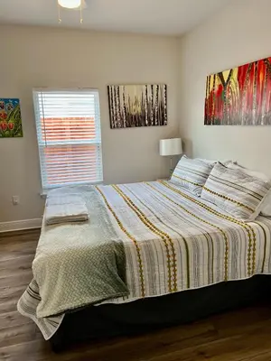 a bedroom with a bed with a striped comforter at Beach Room, for wonderful Vacation in Panama City Beach