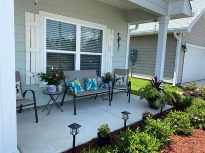a patio with two chairs and a bench on a house at Beach Room, for wonderful Vacation in Panama City Beach