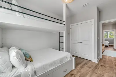 a bedroom with a bunk bed with white walls at 30A Beach House - Beach Ready in Inlet Beach