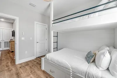a bedroom with white walls and a bunk bed at 30A Beach House - Beach Ready in Inlet Beach