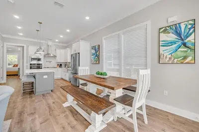 a kitchen and dining room with a wooden table and chairs at 30A Beach House - Beach Ready in Inlet Beach