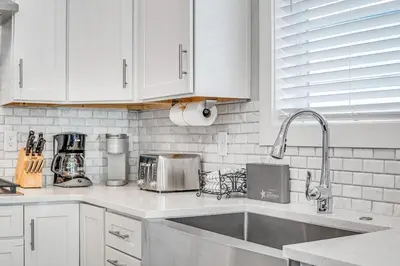 a kitchen with white cabinets and a sink at 30A Beach House - Beach Ready in Inlet Beach
