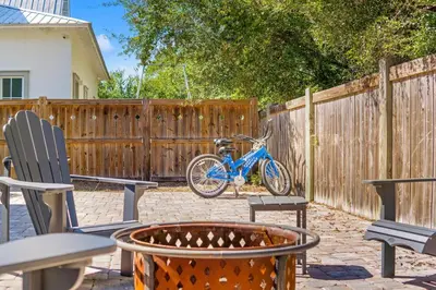 a blue bike parked in a yard next to a fence at 30A Beach House - Beach Ready in Inlet Beach