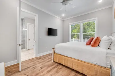 a bedroom with a bed and a tv on the wall at 30A Beach House - Beach Ready in Inlet Beach