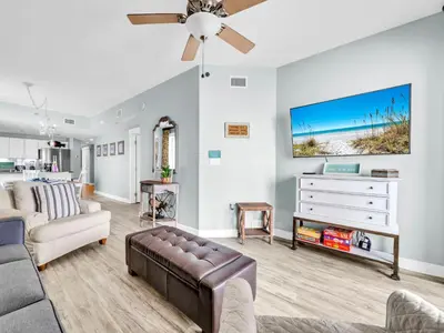 a living room with a couch and a ceiling fan at Grand Panama 1-1401 in Panama City Beach
