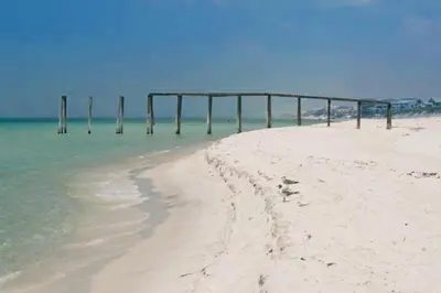 a beach with a pier in the water at Inlet Sands 206- Inlet Dreams in Panama City Beach