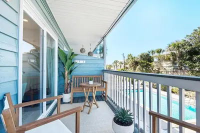 a screened porch with a table and chairs on a house at Inlet Sands 206- Inlet Dreams in Panama City Beach