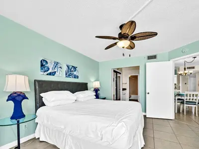 a bedroom with a bed and a ceiling fan at Summerhouse 1009B in Panama City Beach