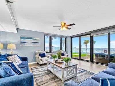 a living room with blue couches and a ceiling fan at Watercrest 103 in Panama City Beach