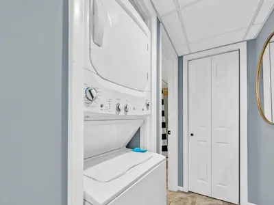 a white laundry room with a washer and dryer at Watercrest 103 in Panama City Beach