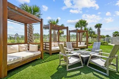 a patio with two gazebos and chairs and a table at Calypso Resort Tower 3 in Panama City Beach